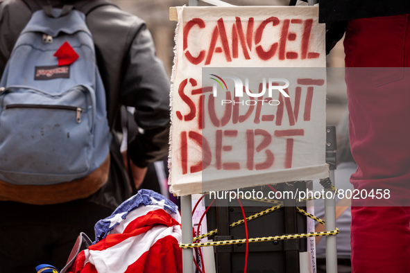 A sign calls for the cancellation of student debt at a rally at the Department of Education.  Students took part in a day of action urging P...