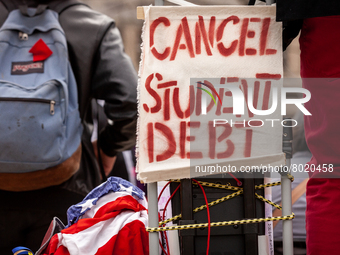 A sign calls for the cancellation of student debt at a rally at the Department of Education.  Students took part in a day of action urging P...