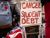 A sign calls for the cancellation of student debt at a rally at the Department of Education.  Students took part in a day of action urging P...