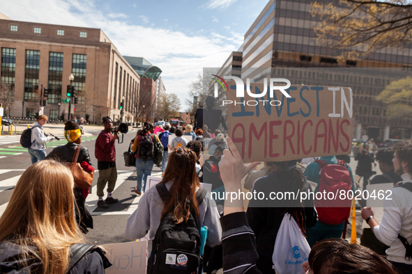 Protesters march around teh Department of Education during a rally to cancel student debt.  Students took part in a day of action urging Pre...