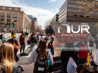 Protesters march around teh Department of Education during a rally to cancel student debt.  Students took part in a day of action urging Pre...