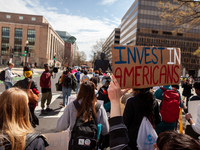 Protesters march around teh Department of Education during a rally to cancel student debt.  Students took part in a day of action urging Pre...