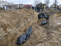 (EDITORS NOTE: Image depicts graphic content)Bodies of civil locals in plastic bags lay in a mass grave in the recaptured by the Ukrainian a...