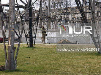 Ukrainian serviceman stands near a body of civilian in the recaptured by the Ukrainian army Bucha city near Kyiv, Ukraine, 04 April 2022. (