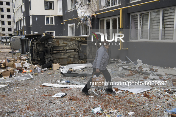 A woman goes near a damaged residential building in the recaptured by the Ukrainian army Bucha city near Kyiv, Ukraine, 04 April 2022. 