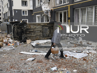 A woman goes near a damaged residential building in the recaptured by the Ukrainian army Bucha city near Kyiv, Ukraine, 04 April 2022. (