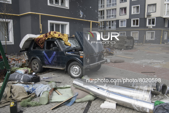 Destroyed civil vehicles  near a damaged residential building in the recaptured by the Ukrainian army Bucha city near Kyiv, Ukraine, 04 Apri...