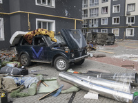 Destroyed civil vehicles  near a damaged residential building in the recaptured by the Ukrainian army Bucha city near Kyiv, Ukraine, 04 Apri...