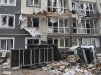 Destroyed civil vehicles  near a damaged residential building in the recaptured by the Ukrainian army Bucha city near Kyiv, Ukraine, 04 Apri...