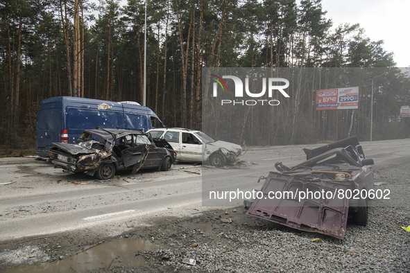 Destroyed civil vehicles  near a damaged residential building in the recaptured by the Ukrainian army Bucha city near Kyiv, Ukraine, 04 Apri...