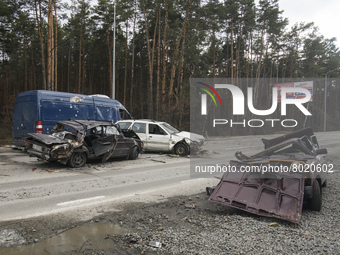 Destroyed civil vehicles  near a damaged residential building in the recaptured by the Ukrainian army Bucha city near Kyiv, Ukraine, 04 Apri...