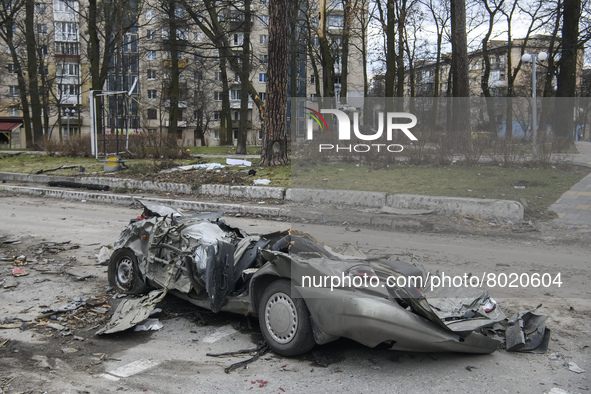 Destroyed civil vehicles  near a damaged residential building in the recaptured by the Ukrainian army Bucha city near Kyiv, Ukraine, 04 Apri...