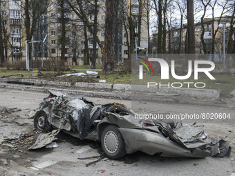 Destroyed civil vehicles  near a damaged residential building in the recaptured by the Ukrainian army Bucha city near Kyiv, Ukraine, 04 Apri...