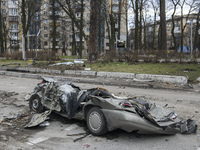 Destroyed civil vehicles  near a damaged residential building in the recaptured by the Ukrainian army Bucha city near Kyiv, Ukraine, 04 Apri...