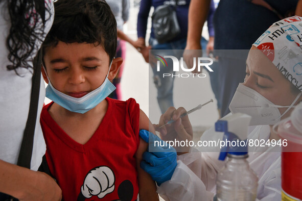 A health system personnel applies a dose of anti-Covid-19 vaccine to a child in the La Parada sector, near the city of Cúcuta on the Colombi...