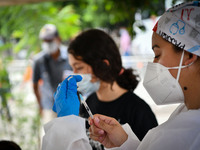 A health system officer prepares a dose of anti-Covid-19 vaccine in the sector of La Parada, near the city of Cúcuta on the Colombian-Venezu...