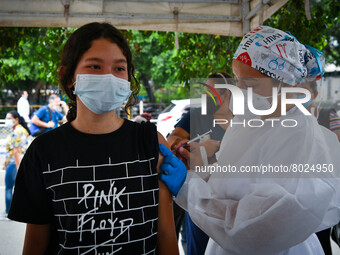 A health system personnel applies a dose of anti-Covid-19 vaccine to a child in the La Parada sector, near the city of Cucuta on the Colombi...