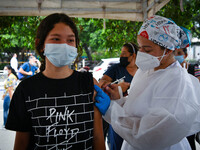 A health system personnel applies a dose of anti-Covid-19 vaccine to a child in the La Parada sector, near the city of Cucuta on the Colombi...