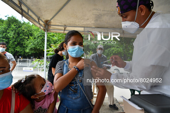 A health system personnel applies a dose of anti-Covid-19 vaccine to a child in the La Parada sector, near the city of Cucuta on the Colombi...