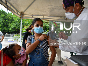 A health system personnel applies a dose of anti-Covid-19 vaccine to a child in the La Parada sector, near the city of Cucuta on the Colombi...