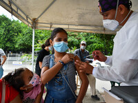 A health system personnel applies a dose of anti-Covid-19 vaccine to a child in the La Parada sector, near the city of Cucuta on the Colombi...