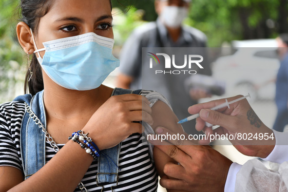 A health system personnel applies a dose of anti-Covid-19 vaccine to a child in the La Parada sector, near the city of Cucuta on the Colombi...