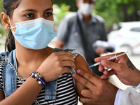 A health system personnel applies a dose of anti-Covid-19 vaccine to a child in the La Parada sector, near the city of Cucuta on the Colombi...