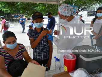 A health system personnel applies a dose of anti-Covid-19 vaccine to a child in the La Parada sector, near the city of Cucuta on the Colombi...