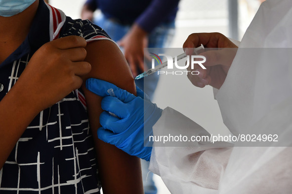 A health system personnel applies a dose of anti-Covid-19 vaccine to a child in the La Parada sector, near the city of Cucuta on the Colombi...