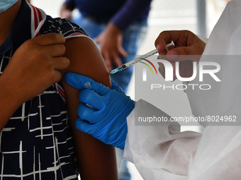 A health system personnel applies a dose of anti-Covid-19 vaccine to a child in the La Parada sector, near the city of Cucuta on the Colombi...