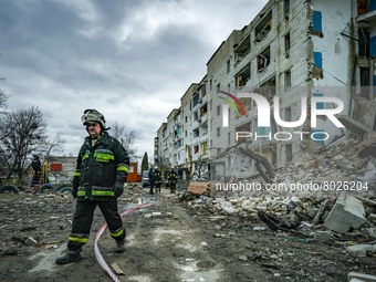 A member of a rescue team passes near a destroyed building after the clashes between the ukrainian and russian armies in Borodianka during t...