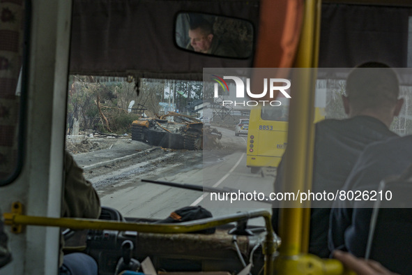 A minibus passes near a destroyed russian tank in the outskirts of Borodianka, there were hard combats in the city between russian and ukrai...