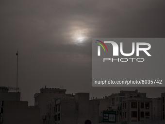 Sun shines over residential buildings in Tehran during a polluted air, on April 8, 2022. (