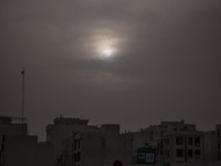 Sun shines over residential buildings in Tehran during a polluted air, on April 8, 2022. (