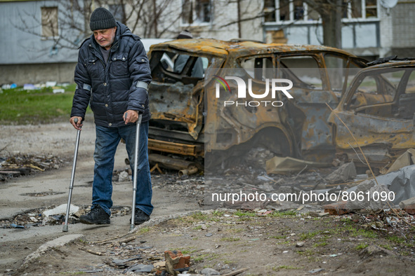 A man takes a walk with his crutches near his house after being wounded in a russian shelling over Chernihiv, Ukraine. 