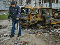A man takes a walk with his crutches near his house after being wounded in a russian shelling over Chernihiv, Ukraine. (