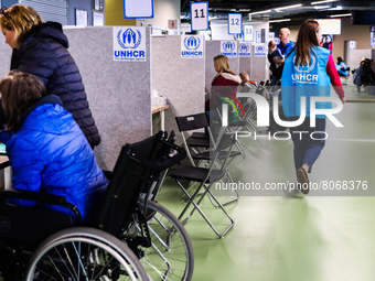 Refugees from Ukraine who fled to Poland after Russian attack are seen at a cash enrolment centre opened by UNHCR, the UN Refugee Agency, at...