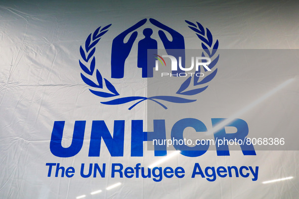 UNHCR logo is seen at a cash enrolment centre opened by UNHCR for refugees from Ukraine who fled to Poland after Russian attack, at a at TAU...