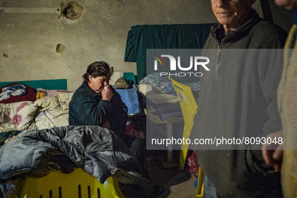 A woman waits in  a shelter during a russian shelling over the village of Luch, a village close to the frontline in the Mykolaiv region, Ukr...