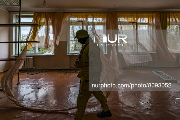 Ukrainian soldier patrols the village of Luch inside destroyed building by the russian shelling, a village close to the frontline in the Myk...