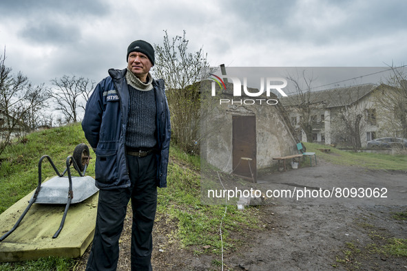 A civilian stands in the entrance of a shelter in Luch after a russian shelling stop during the combats between ukrainian and russian armies...