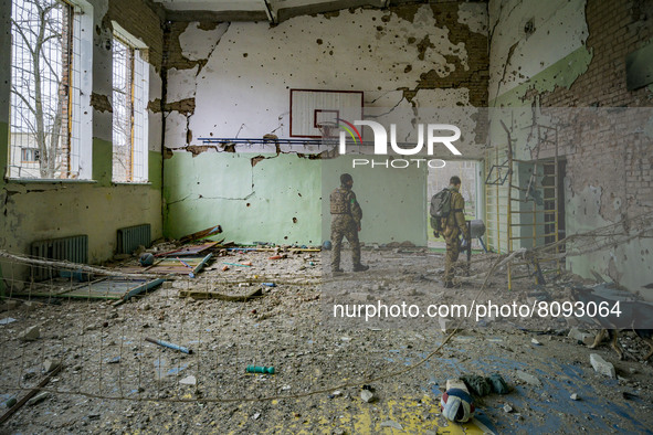 Ukrainian soldiers check the sport center of a school in  the village of Luch, a village close to the frontline in the Mykolaiv region, Ukra...