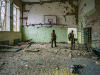 Ukrainian soldiers check the sport center of a school in  the village of Luch, a village close to the frontline in the Mykolaiv region, Ukra...