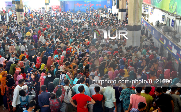 People queue to buy advance tickets for Eid train trips at Dhaka's Kamalapur Railway Station on Sunday, Apr 24, 2022. Tickets are being sold...