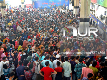 People queue to buy advance tickets for Eid train trips at Dhaka's Kamalapur Railway Station on Sunday, Apr 24, 2022. Tickets are being sold...