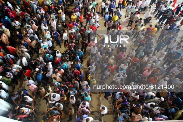 People queue to buy advance tickets for Eid train trips at Dhaka's Kamalapur Railway Station on Sunday, Apr 24, 2022. Tickets are being sold...