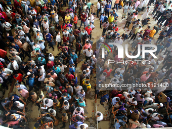 People queue to buy advance tickets for Eid train trips at Dhaka's Kamalapur Railway Station on Sunday, Apr 24, 2022. Tickets are being sold...