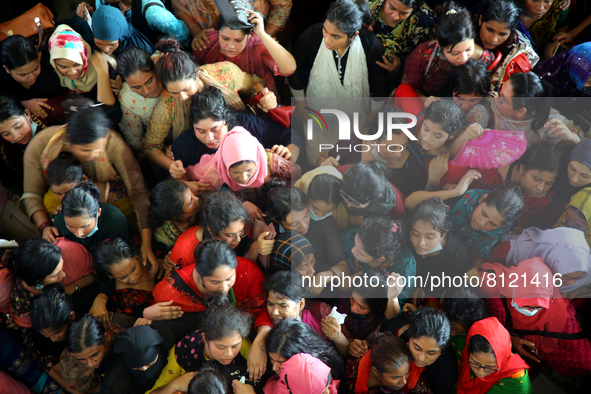 People queue to buy advance tickets for Eid train trips at Dhaka's Kamalapur Railway Station on Sunday, Apr 24, 2022. Tickets are being sold...