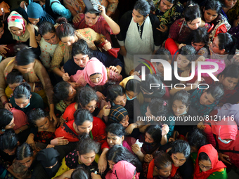 People queue to buy advance tickets for Eid train trips at Dhaka's Kamalapur Railway Station on Sunday, Apr 24, 2022. Tickets are being sold...