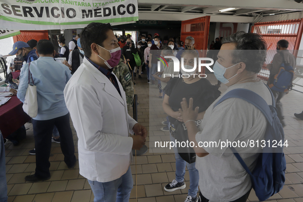 Medical personnel offer reports to people in a vaccination unit at the Constitución de 1917 metro station in Mexico City, where the AstraZen...